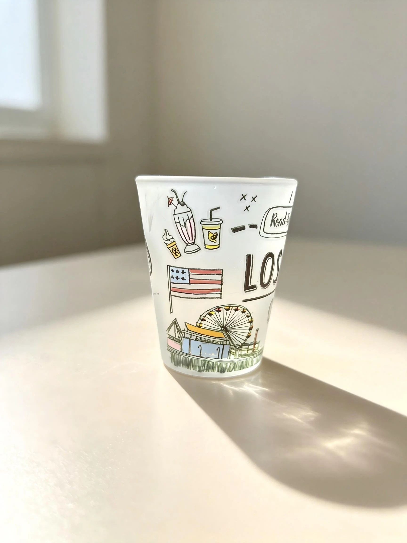 White frosted glass cup with city and fairground line artwork