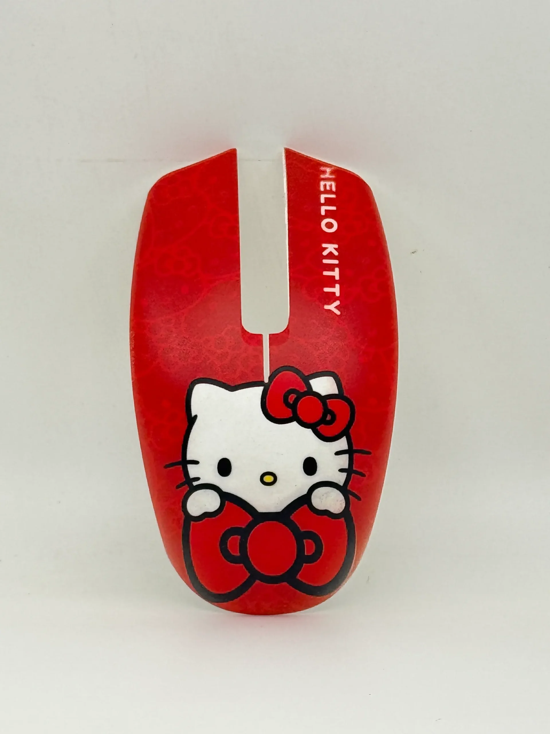 Red computer mouse shell with white cartoon character face and bow artwork