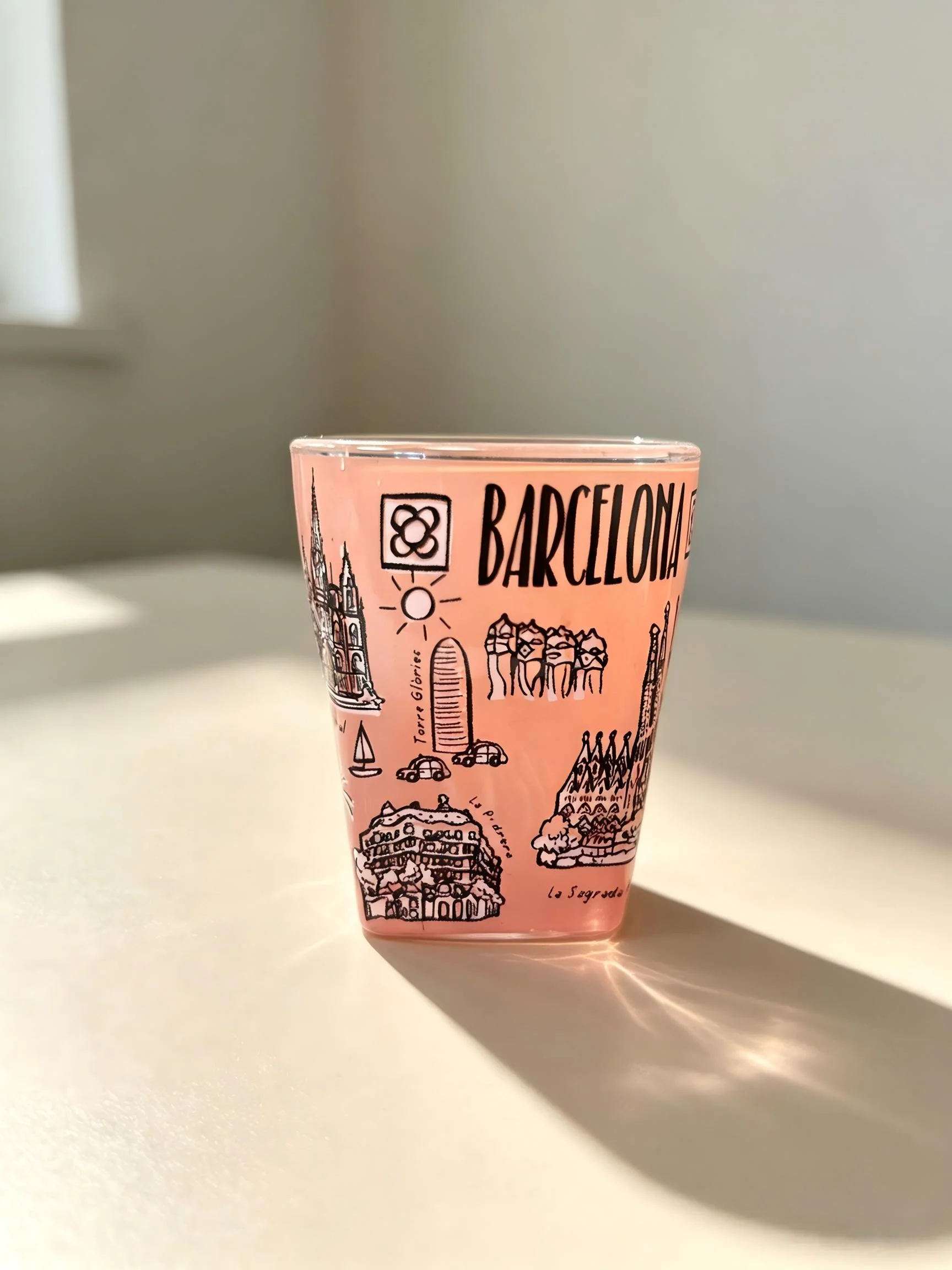 Pink glass cup with Barcelona city landmark line artwork